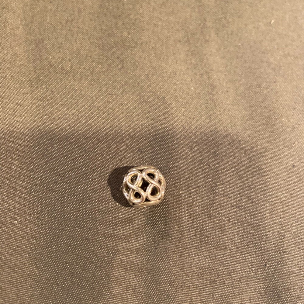 Pandora charm silver with infinity design.